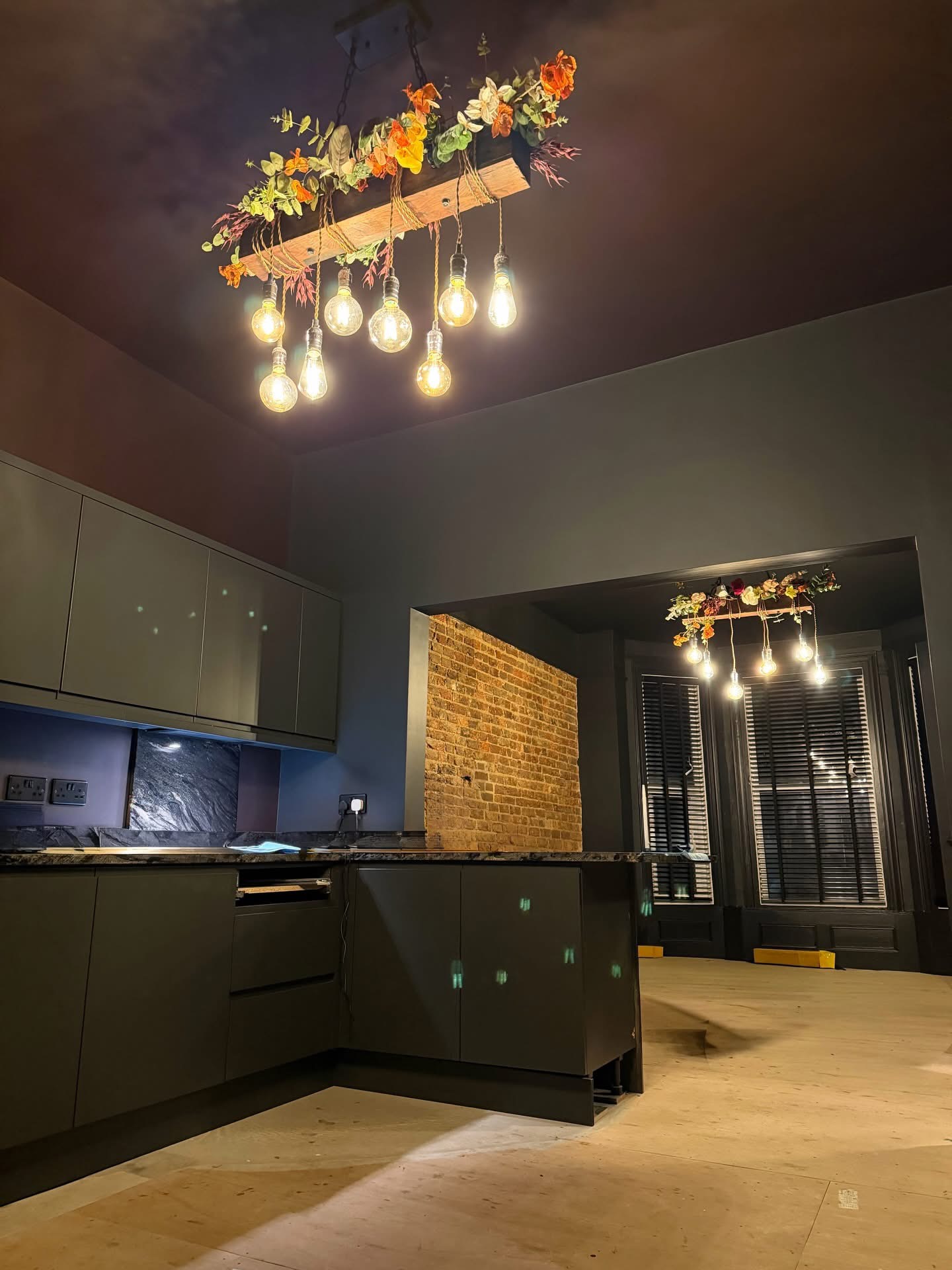 Bespoke kitchen pendant lighting with Edison bulbs and floral feature beam